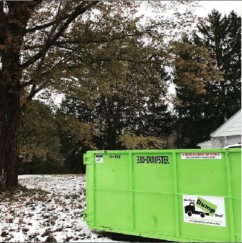Dumpster in snowy yard